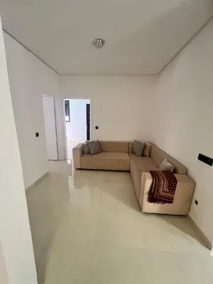 a living room with a couch in the middle at شقق الشرايبي للعائلات فقط in Beni Mellal