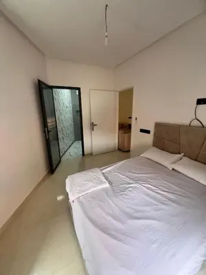 a bedroom with a large white bed in it at شقق الشرايبي للعائلات فقط in Beni Mellal