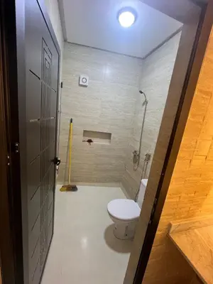 a bathroom with a toilet and a shower at شقق الشرايبي للعائلات فقط in Beni Mellal