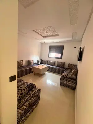 a large living room with couches and a table at شقق الشرايبي للعائلات فقط in Beni Mellal