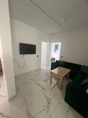 a living room with a couch and a table at شقق الشرايبي للعائلات فقط in Beni Mellal