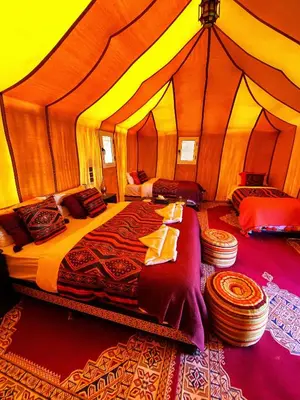 a bedroom with a large bed in a tent at Merzouga Paradise Luxury Camp in Merzouga