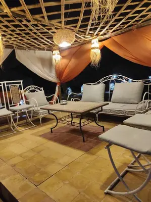 a room with couches and chairs in a stage at Merzouga Desert Experience Camp-Erg Chebbi Sunset & Camel Ride in Merzouga