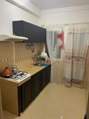 a kitchen with a stove and a counter top at Bel Appartement à louer à Fès in Fès