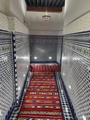 a hallway with a colorful rug in a room at M & S Guest House in Fès