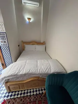 a small bedroom with a bed and a couch at M & S Guest House in Fès