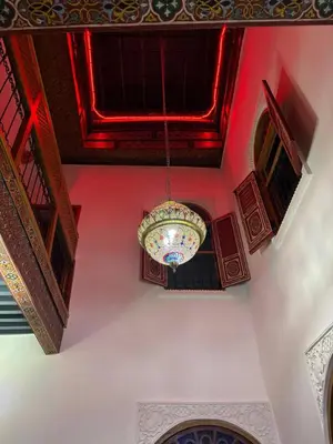 a chandelier hanging from a ceiling in a building at M & S Guest House in Fès
