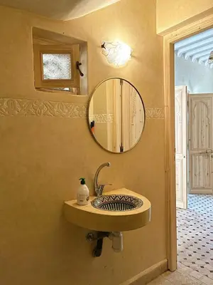 a bathroom with a sink and a mirror on the wall at Dar Dahlia Atlas Valley in Oulad Akkou
