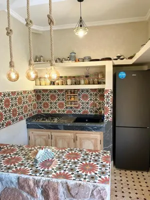 a kitchen with a stove and a counter top at Dar Dahlia Atlas Valley in Oulad Akkou