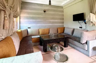 a living room with a couch and a table at Dar Dahlia Atlas Valley in Oulad Akkou