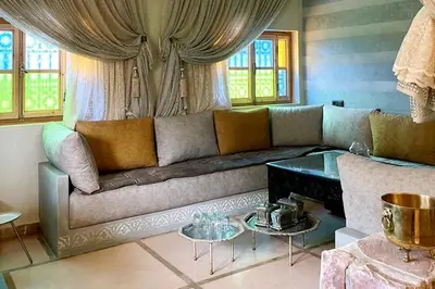 a living room with a couch and two tables at Dar Dahlia Atlas Valley in Oulad Akkou