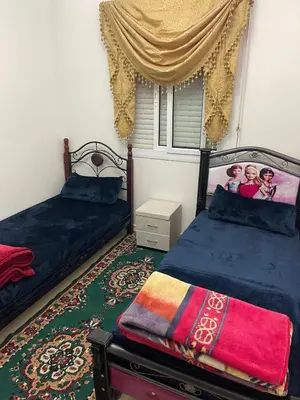 a bedroom with two beds and a window at Bel appartement à louer à Fès in Fès