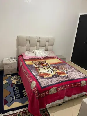 a bedroom with a bed with a tiger blanket at Bel appartement à louer à Fès in Fès