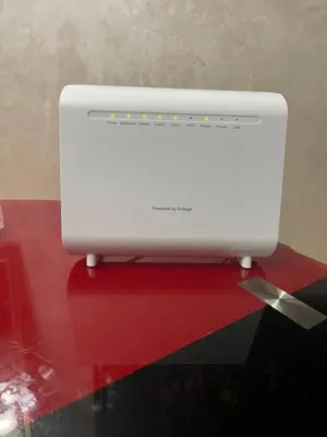 a white computer monitor sitting on a red table at Bel appartement à louer à Fès in Fès