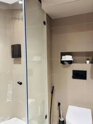 a bathroom with a shower and a toilet at Majestic apt Casa City Center in Oulad Akkou