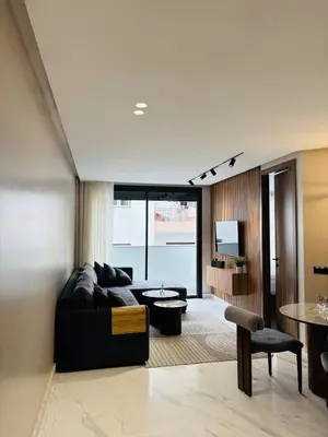 a living room with a couch and a table at Majestic apt Casa City Center in Oulad Akkou