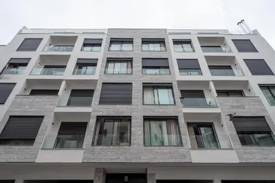 a tall white building with many windows at Majestic apt Casa City Center in Oulad Akkou