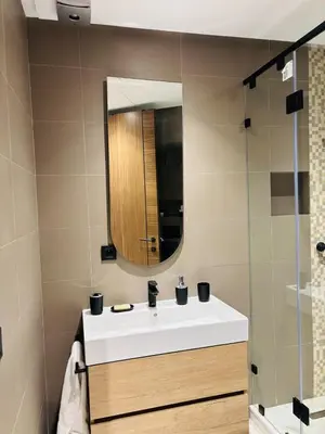 a bathroom with a white sink and a mirror at Majestic apt Casa City Center in Oulad Akkou