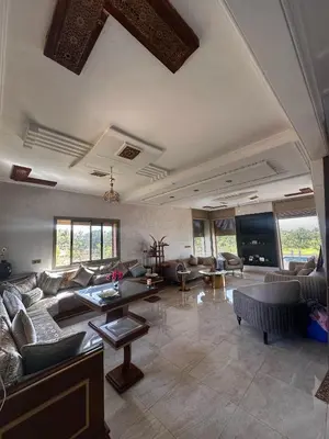 a large living room with couches and a tv at Villa Adam in Meknès