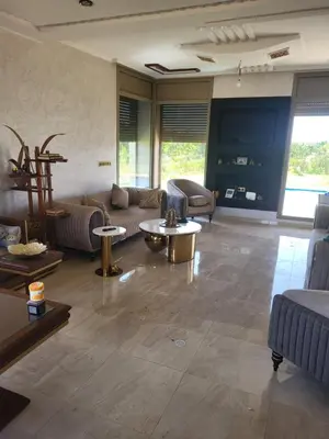 a large living room with couches and tables at Villa Adam in Meknès