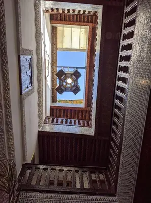 an overhead view of a stairway with a mirror at Dar Omar in Fès