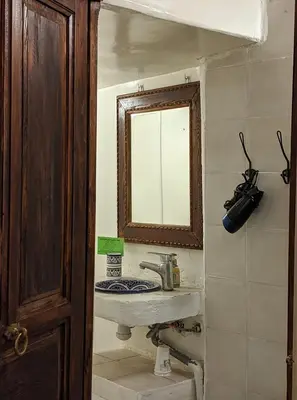 a bathroom with a sink and a mirror at Dar Omar in Fès