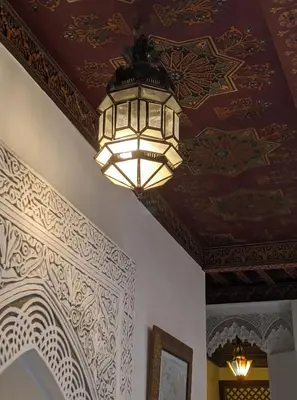 a chandelier hanging from a ceiling in a room at Dar Omar in Fès