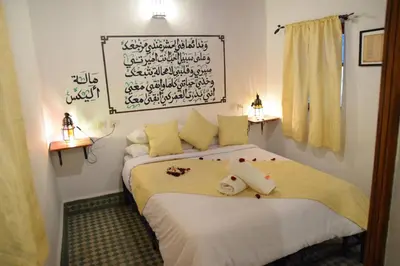 a bedroom with two beds and a sign on the wall at Dar Omar in Fès
