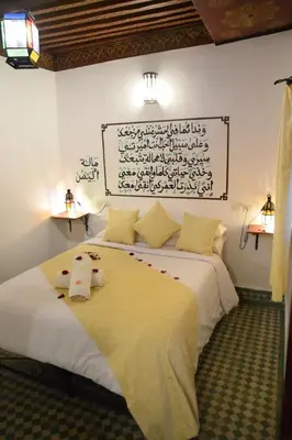 a bedroom with a bed with two towels on it at Dar Omar in Fès