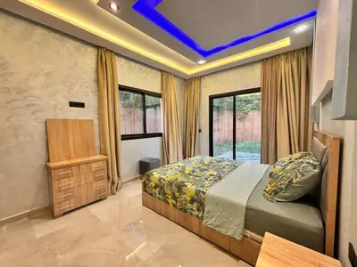 a bedroom with a bed and a tv in it at Villa avec piscine Aghmat in Aghmat