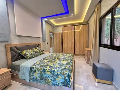 a bedroom with a bed with a blue ceiling at Villa avec piscine Aghmat in Aghmat