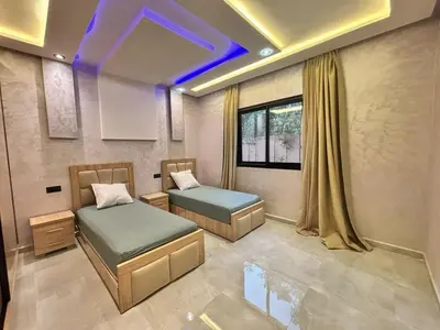a room with two beds and a window at Villa avec piscine Aghmat in Aghmat