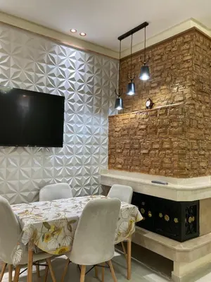 a dining room with a table and chairs and a tv at Cozy Family-Friendly Stay with Unique Decor in Ifrane in Ifrane