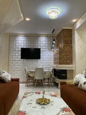 a living room with a couch and a tv on a wall at Cozy Family-Friendly Stay with Unique Decor in Ifrane in Ifrane