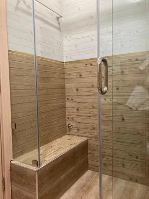 a bathroom with a shower with a wooden tub at Cozy Family-Friendly Stay with Unique Decor in Ifrane in Ifrane