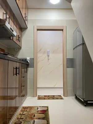 a kitchen with a door in the middle of a kitchen at Cozy Family-Friendly Stay with Unique Decor in Ifrane in Ifrane