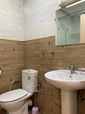 a bathroom with a toilet and a sink at Cozy Family-Friendly Stay with Unique Decor in Ifrane in Ifrane