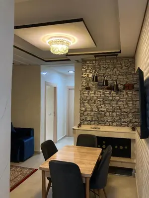 a dining room with a table and a fireplace at Modern Apartment in Ifrane in Ifrane