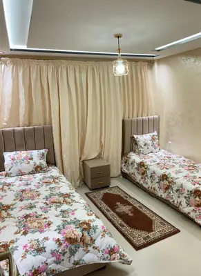 a bedroom with two beds and a window at Modern Apartment in Ifrane in Ifrane