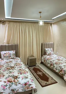 a bedroom with two beds and a window at Modern Apartment in Ifrane in Ifrane
