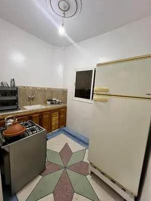 a kitchen with a refrigerator and a stove at Au centre de la ville pour les familles seulement in Khenifra