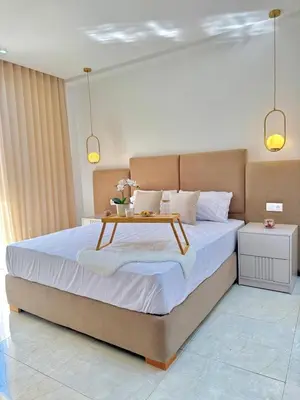 a bedroom with a large bed with a table on it at La casa famille in Oulad Akkou