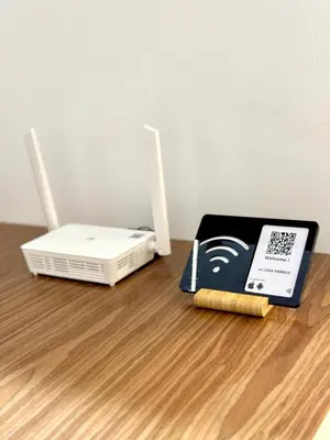 a modem and a book on a wooden table at La casa famille in Oulad Akkou
