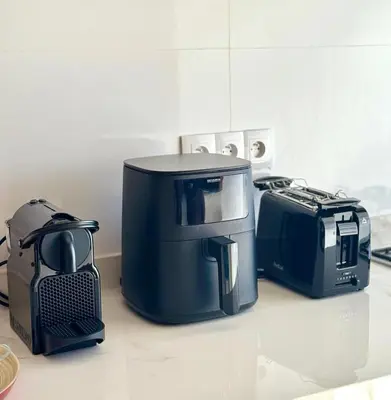 a coffee maker and toaster sitting on a counter at La casa famille in Oulad Akkou