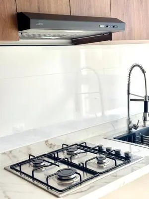 a stove top in a kitchen with a sink at La casa famille in Oulad Akkou