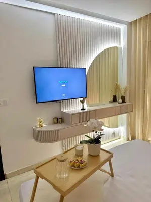 a living room with a tv on a wall at La casa famille in Oulad Akkou