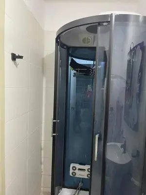 a shower with a glass door in a bathroom at khalid in Oulad Akkou