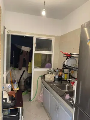 a messy kitchen with a sink and a window at khalid in Oulad Akkou