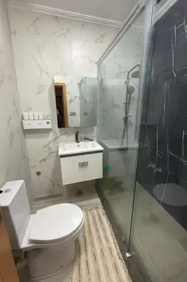 a bathroom with a toilet and a shower and a sink at Appartement Pam Pam in Fès