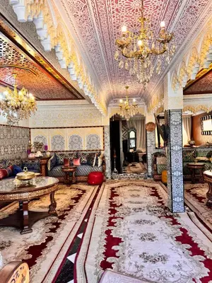a living room with a couch and a chandelier at Villat Riad, fête style marocain in Oulad Akkou